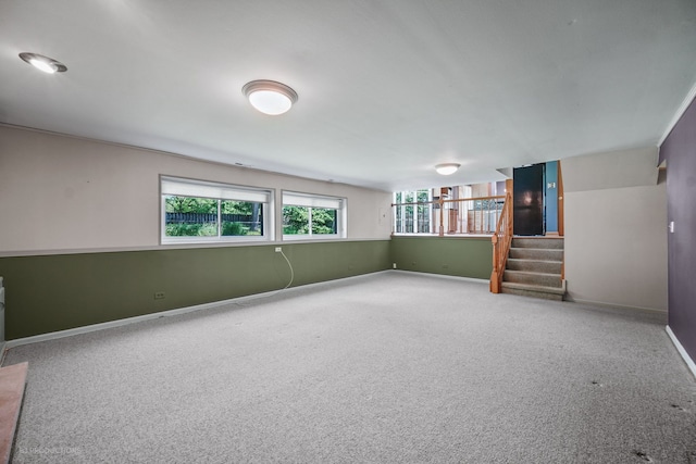 basement with a wealth of natural light and carpet floors