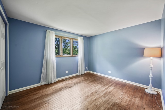 unfurnished room featuring hardwood / wood-style flooring