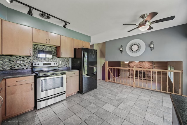 kitchen with black refrigerator, decorative backsplash, track lighting, ceiling fan, and stainless steel electric range oven