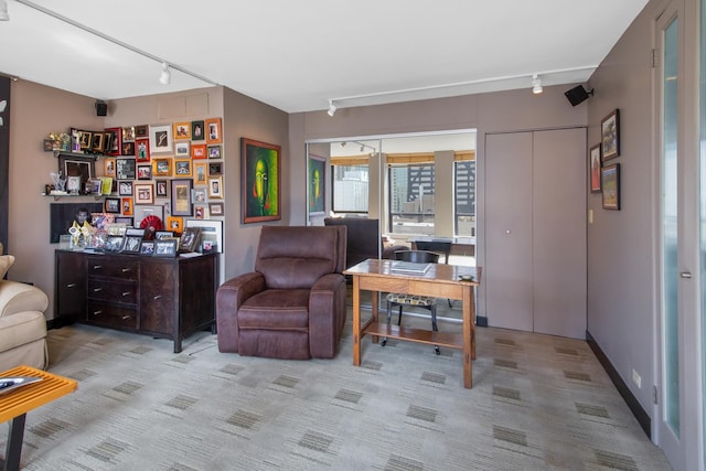 office space with rail lighting and light colored carpet