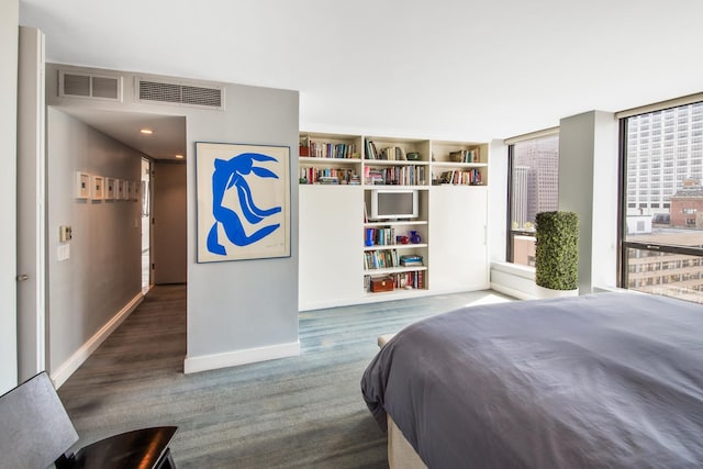 bedroom with baseboards and visible vents