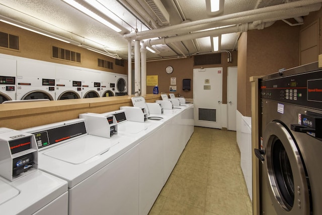 laundry room with light tile floors and washing machine and clothes dryer