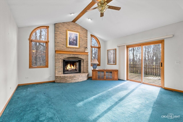 unfurnished living room featuring carpet flooring, vaulted ceiling, a fireplace, and ceiling fan