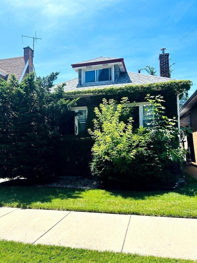 view of property exterior with a lawn