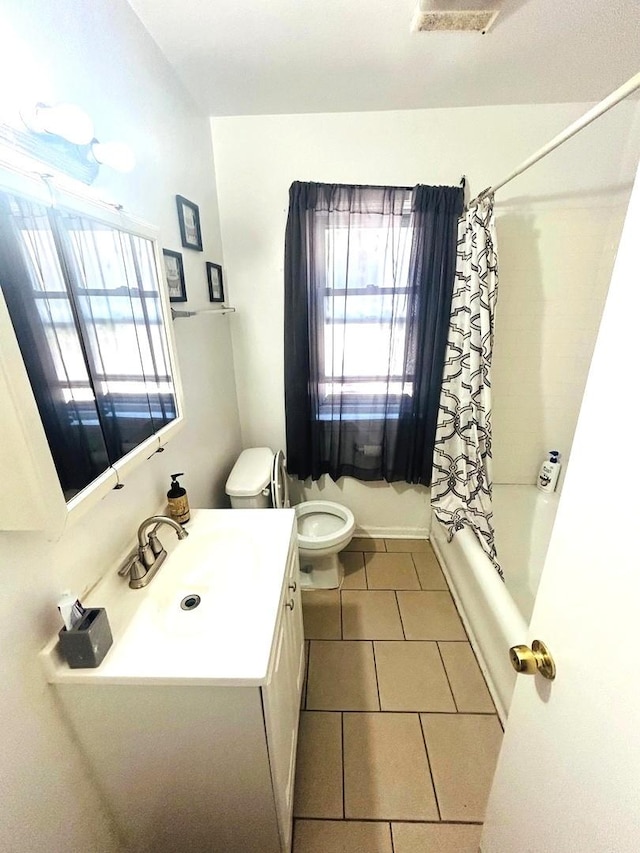 full bathroom with tile patterned flooring, vanity, shower / tub combo with curtain, and toilet