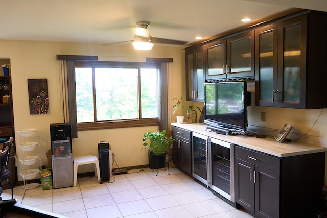 kitchen with beverage cooler, a ceiling fan, light tile patterned flooring, light countertops, and recessed lighting