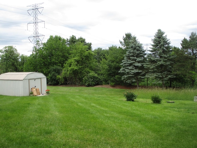 view of yard with an outbuilding and a shed