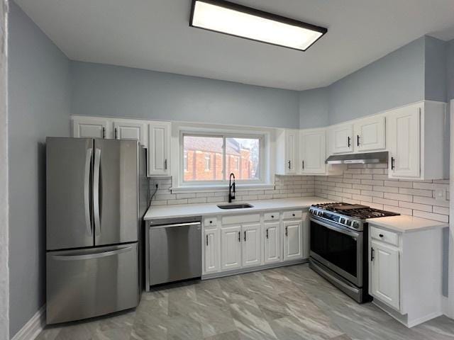 kitchen featuring a sink, appliances with stainless steel finishes, white cabinets, and under cabinet range hood