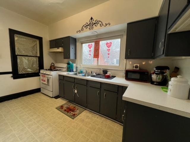 kitchen with sink and white range with gas cooktop