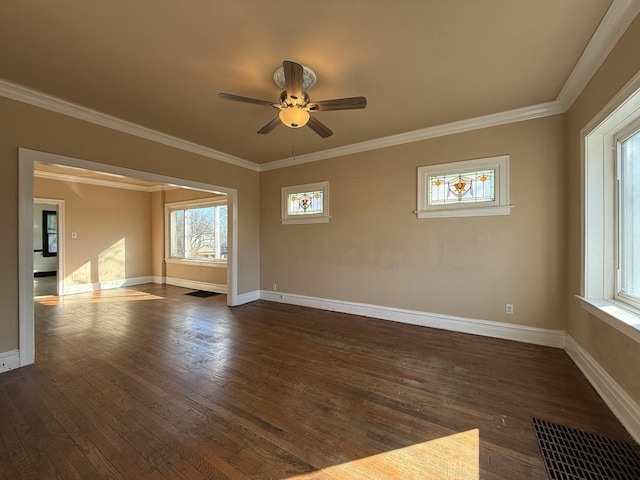 unfurnished room featuring visible vents, baseboards, dark wood-type flooring, and ornamental molding