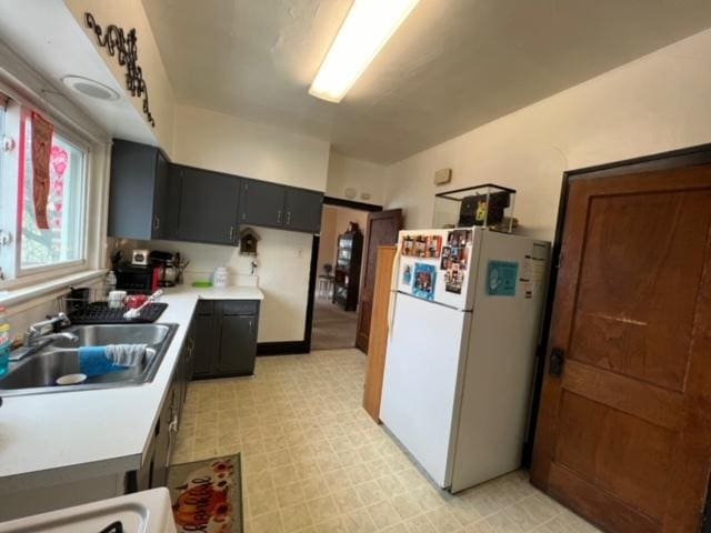 kitchen featuring white fridge and sink