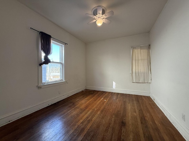 unfurnished room with baseboards, ceiling fan, and wood finished floors