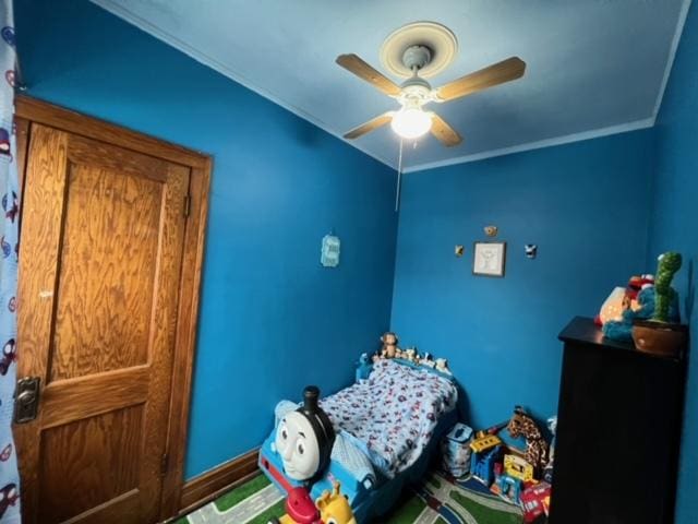 bedroom with ceiling fan and crown molding