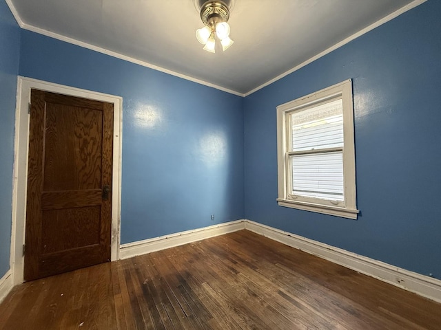 spare room featuring baseboards, hardwood / wood-style flooring, ceiling fan, and ornamental molding