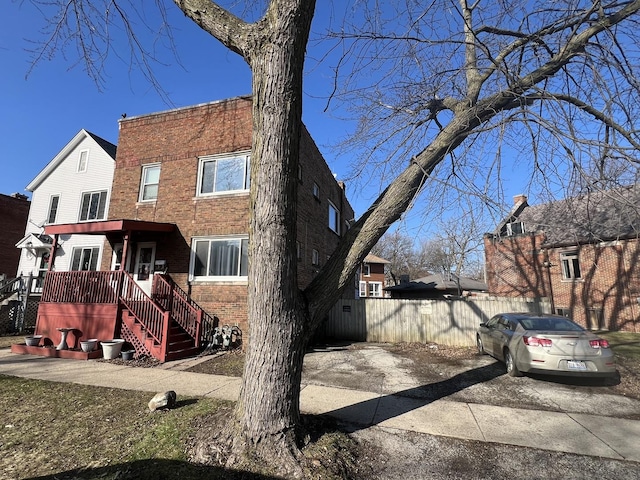 view of front of property with fence and brick siding