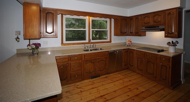 kitchen featuring dishwasher, black electric stovetop, sink, light hardwood / wood-style floors, and kitchen peninsula