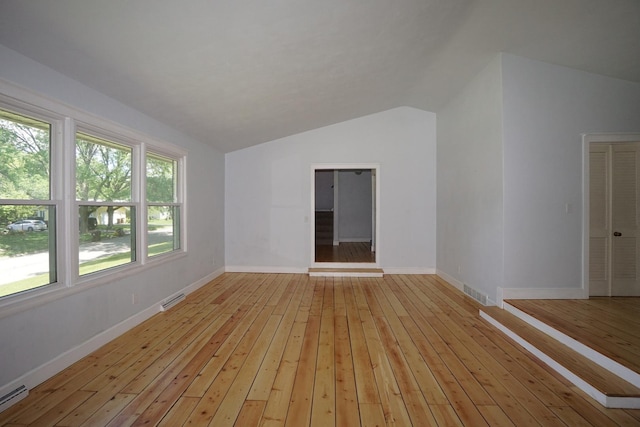 interior space featuring vaulted ceiling and light wood-type flooring