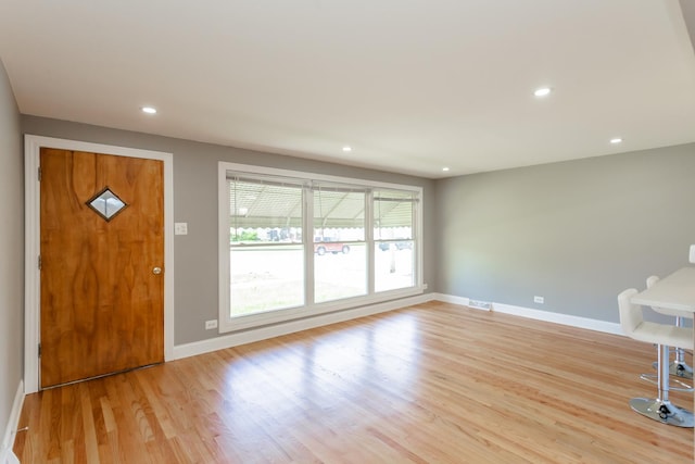 entrance foyer with baseboards, light wood-style floors, and recessed lighting