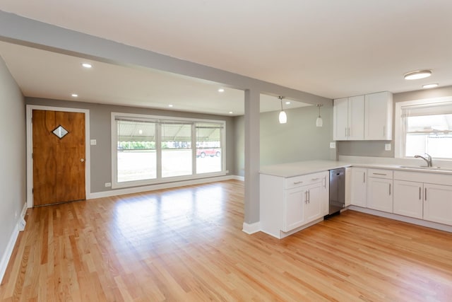 kitchen with open floor plan, dishwasher, a sink, and a wealth of natural light