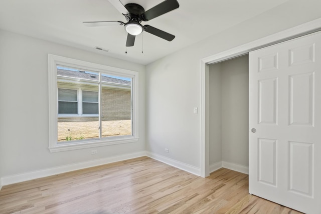 unfurnished bedroom with a closet, light hardwood / wood-style flooring, and ceiling fan