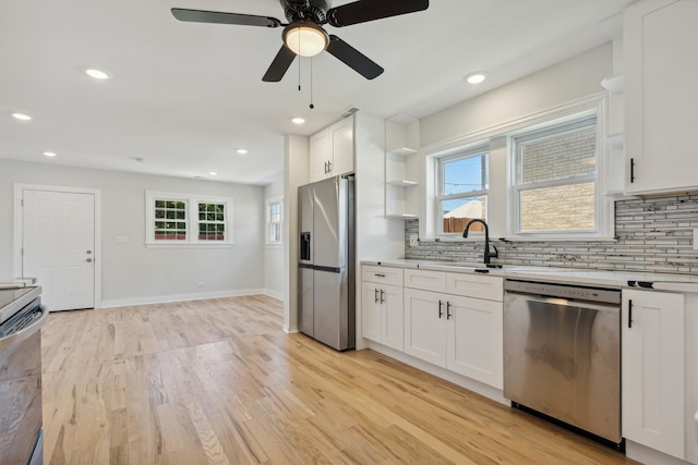 kitchen featuring light hardwood / wood-style flooring, white cabinets, and stainless steel appliances