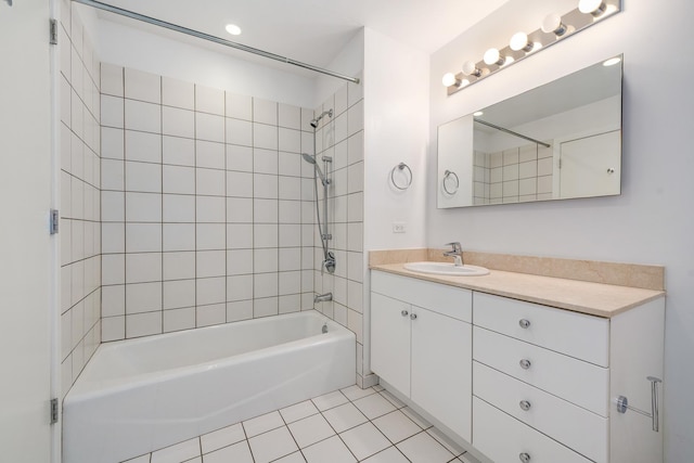 bathroom featuring tile patterned floors, vanity, and tiled shower / bath