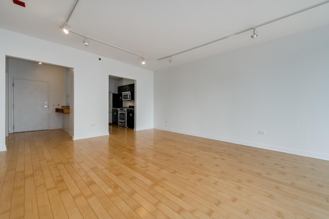 spare room with light hardwood / wood-style flooring