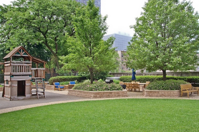 surrounding community with a playground, a yard, and a patio