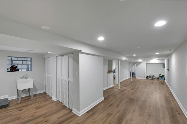 basement with hardwood / wood-style floors