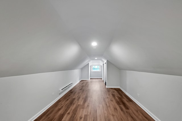 bonus room with a baseboard radiator, lofted ceiling, and dark wood-type flooring