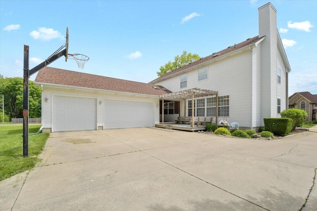 view of front of home featuring an attached garage, a chimney, a pergola, and concrete driveway