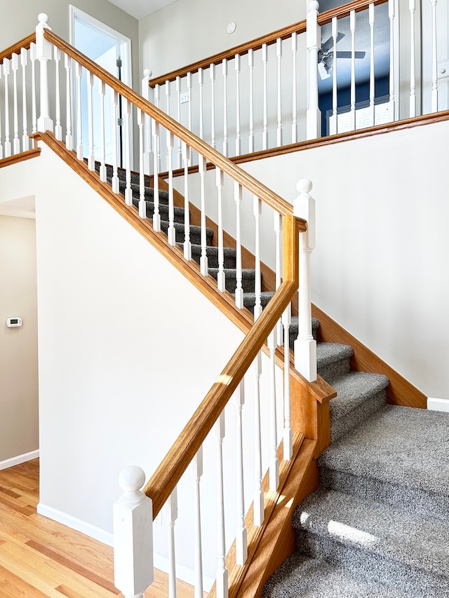 stairs with baseboards and wood finished floors