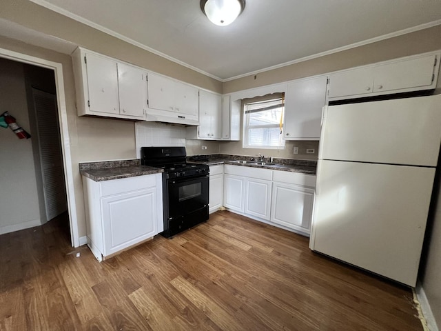 kitchen featuring gas stove, white cabinetry, white fridge, and light wood-type flooring