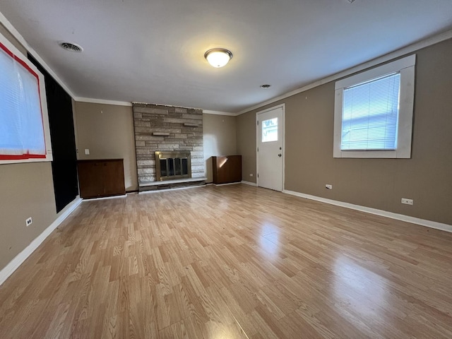 unfurnished living room with a fireplace, light hardwood / wood-style floors, and ornamental molding