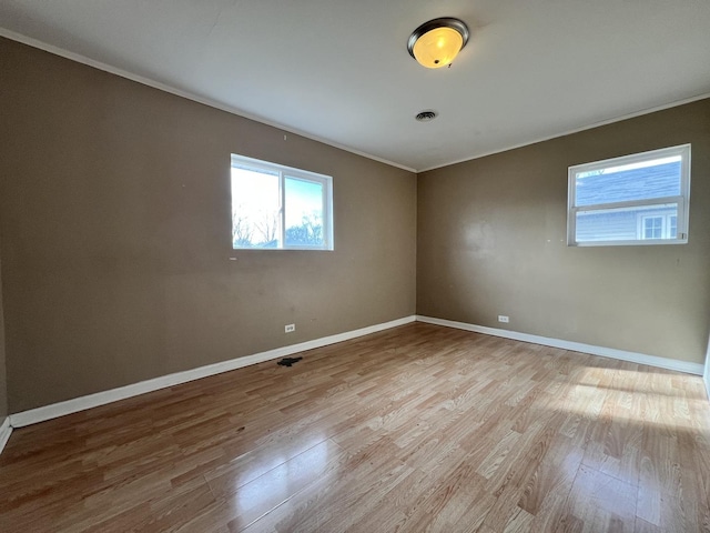 unfurnished room with light hardwood / wood-style floors and ornamental molding