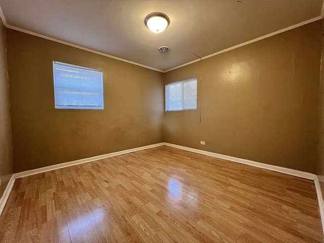 unfurnished room with crown molding and hardwood / wood-style floors