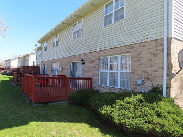 back of house featuring a yard and a deck