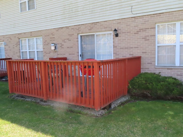 view of gate with a yard and a deck