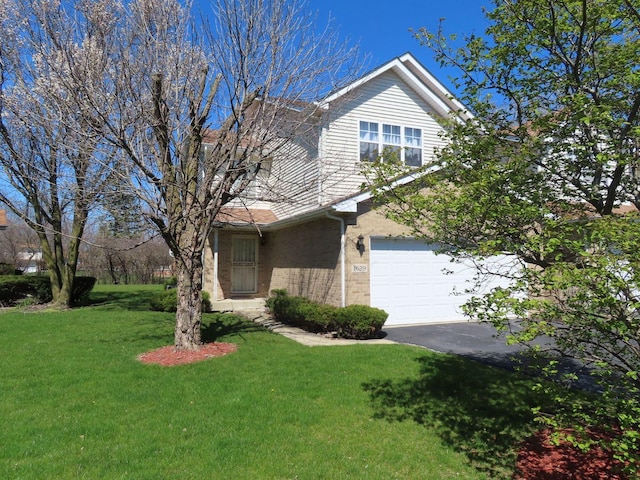 view of front of property featuring a garage and a front lawn