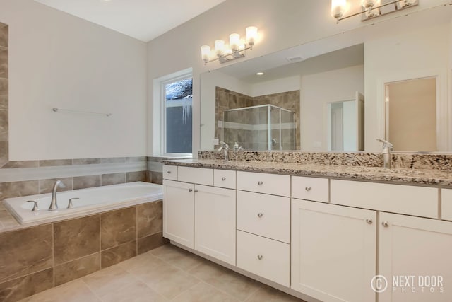 bathroom featuring vanity, tile patterned flooring, and plus walk in shower