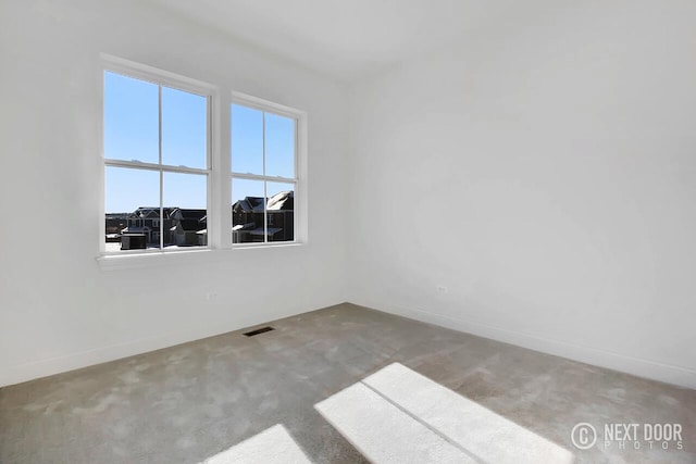 unfurnished room featuring carpet flooring