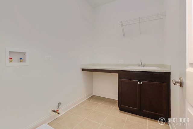 clothes washing area featuring hookup for a gas dryer, hookup for a washing machine, light tile patterned flooring, and sink