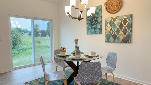 dining room featuring hardwood / wood-style flooring, a notable chandelier, and a wealth of natural light