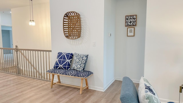 hall featuring light wood finished floors and baseboards