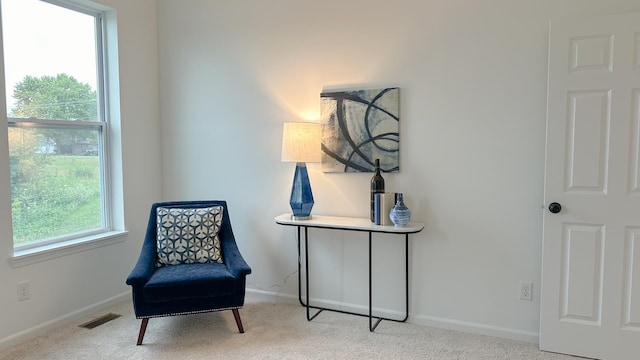 sitting room with light carpet, baseboards, and visible vents