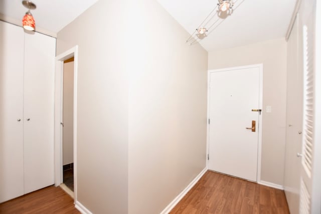 corridor with light hardwood / wood-style floors