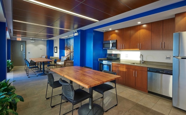 kitchen with sink, light tile floors, and appliances with stainless steel finishes