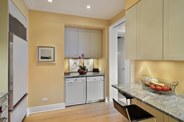 kitchen featuring light wood-type flooring, paneled refrigerator, white dishwasher, and light stone counters