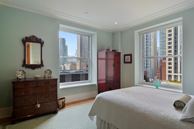 bedroom featuring light hardwood / wood-style flooring and ornamental molding