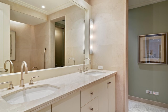 bathroom featuring crown molding, vanity, and tile walls